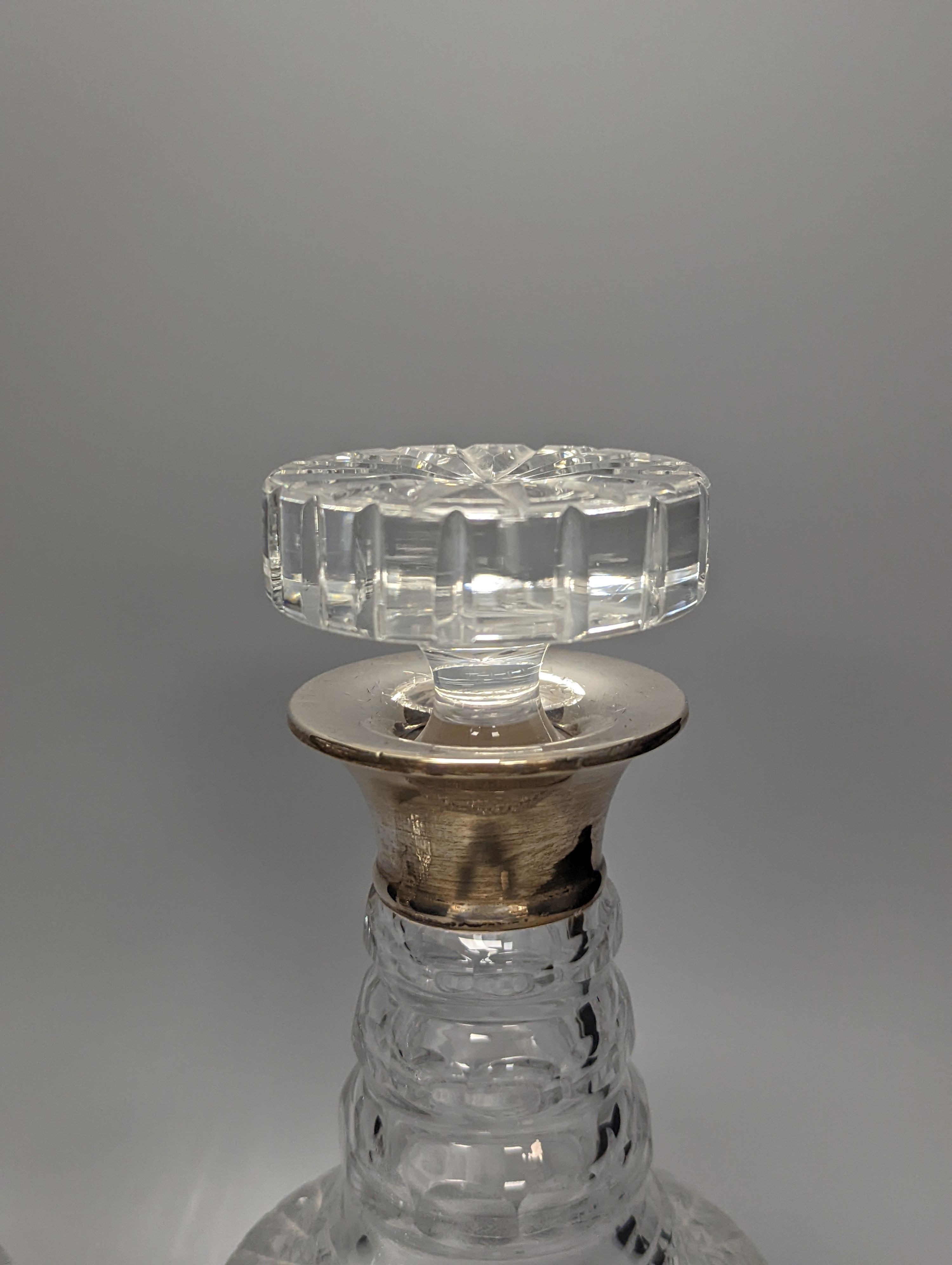 A pair of silver mounted glass decanters, with stoppers, height 28cm